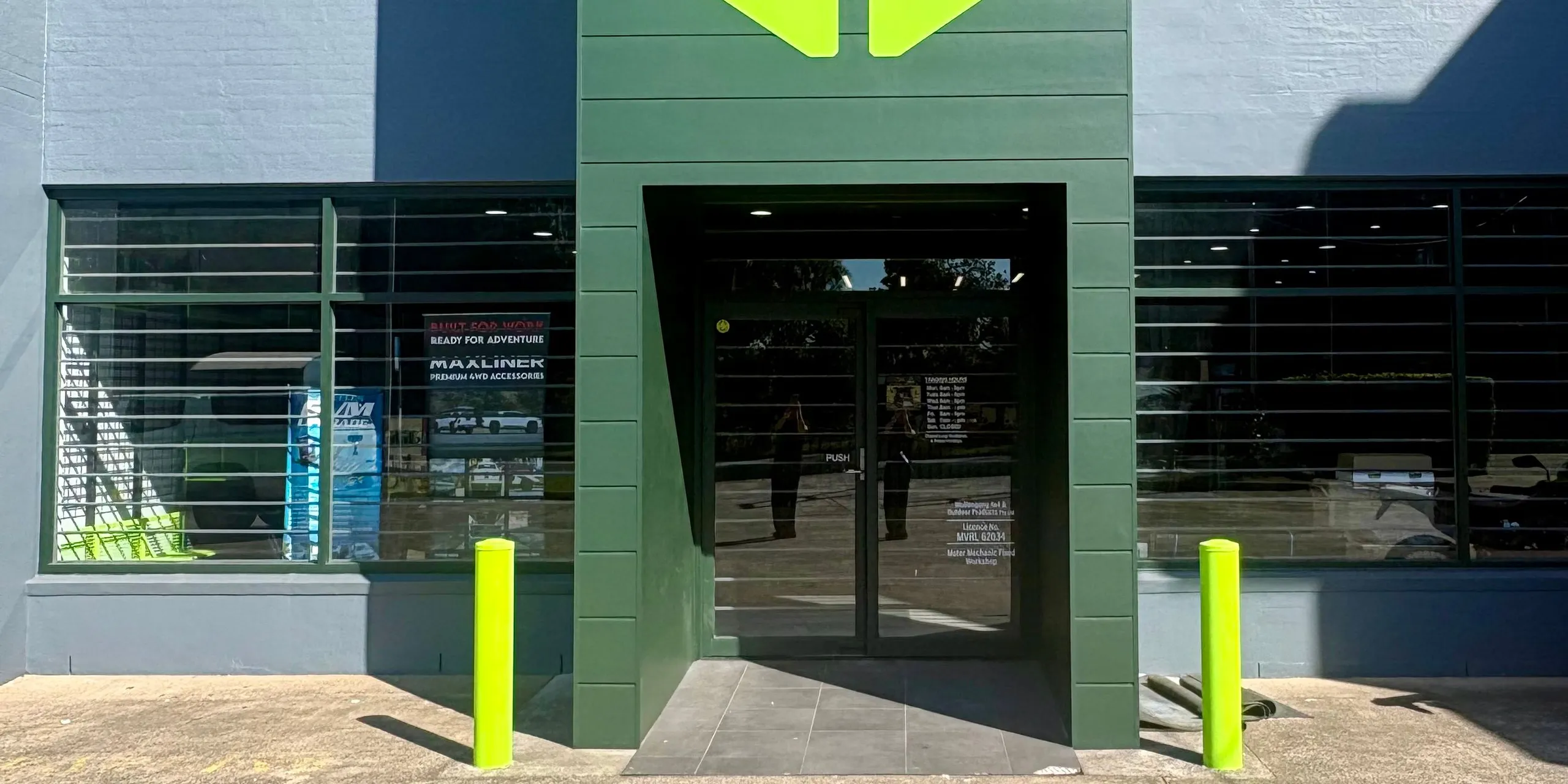 The front door of the IRONMAN 4X4 showroom, between two green bollards