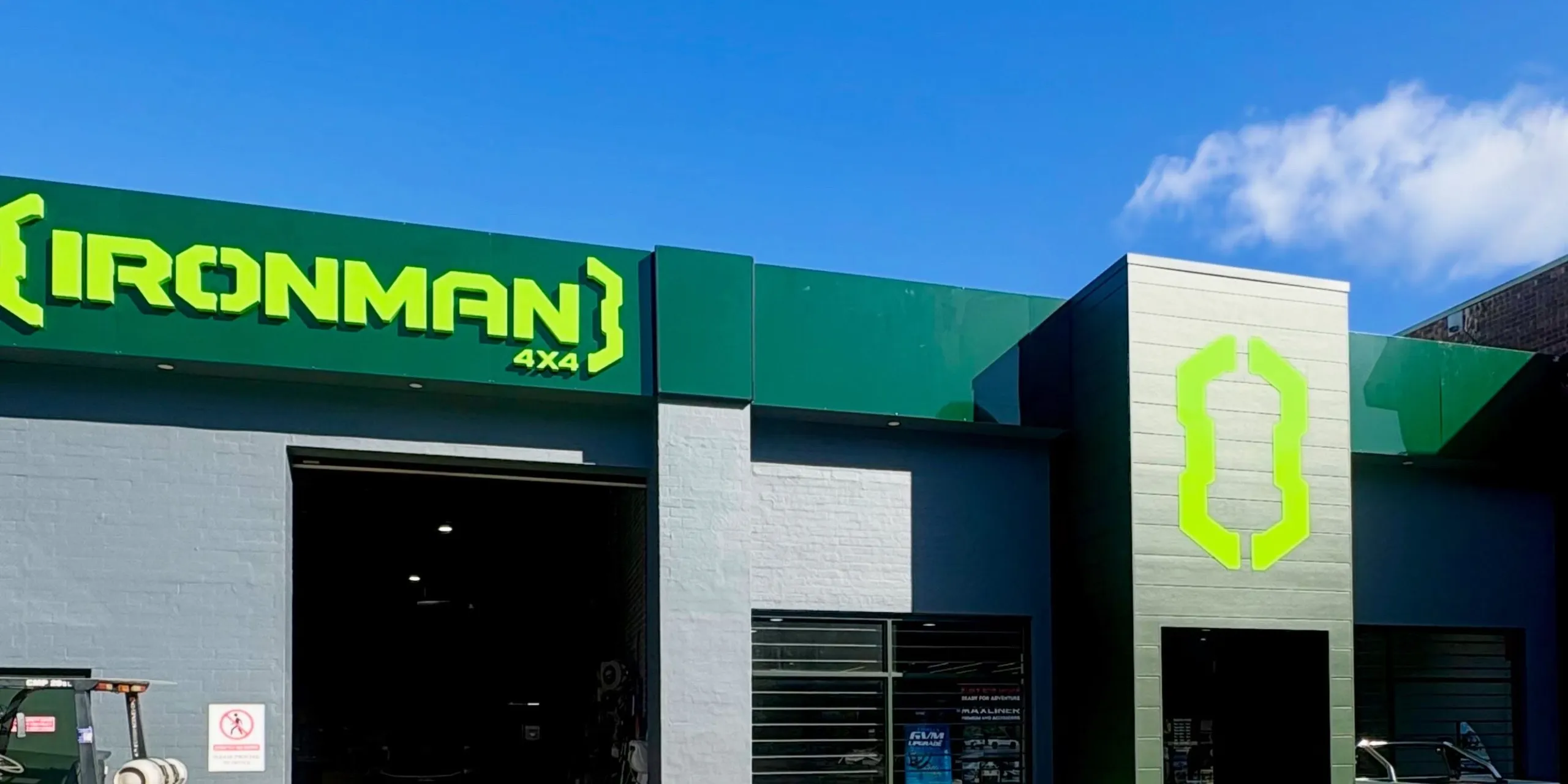 The IRONMAN 4X4 store frontage, with the workshop roller door and the showroom entrance