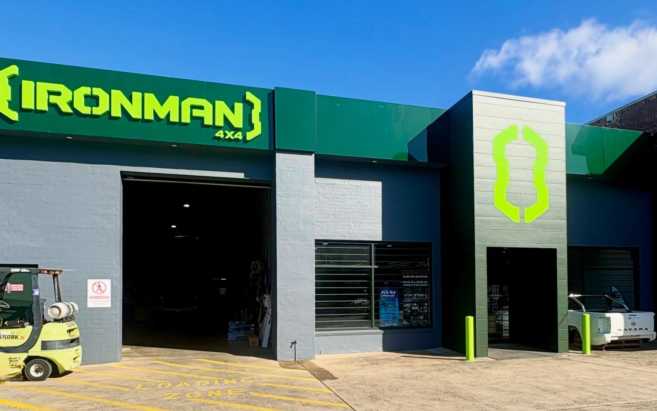 The IRONMAN 4X4 store on Corrimal Street, with the workshop roller door open and the showroom entrance