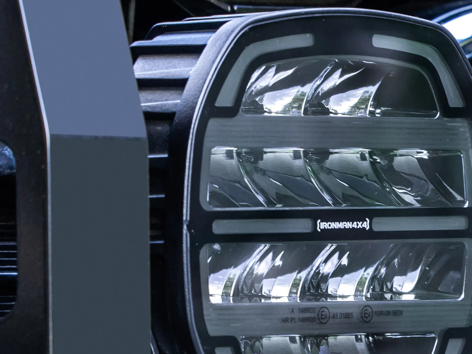 An IRONMAN 4X4 LED driving light mounted behind a bull bar
