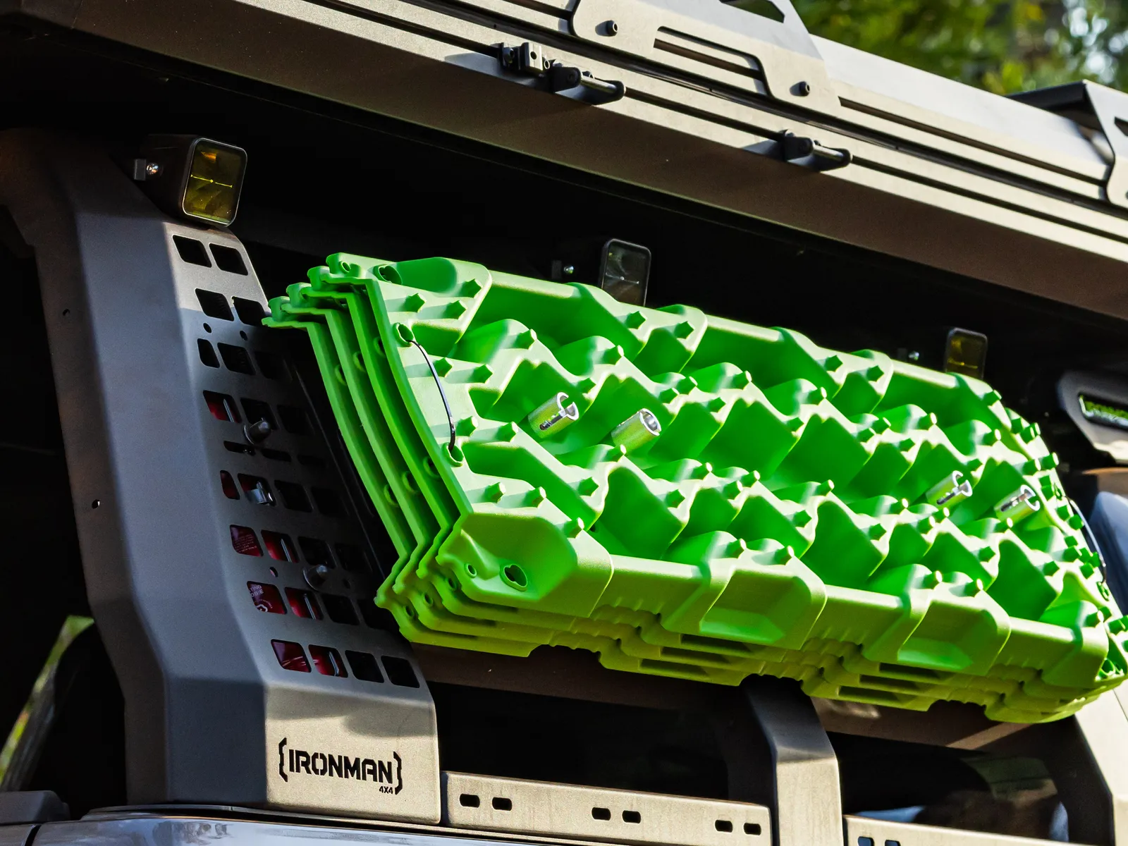 A stack of recovery boards carried on an IRONMAN 4X4 tub rack