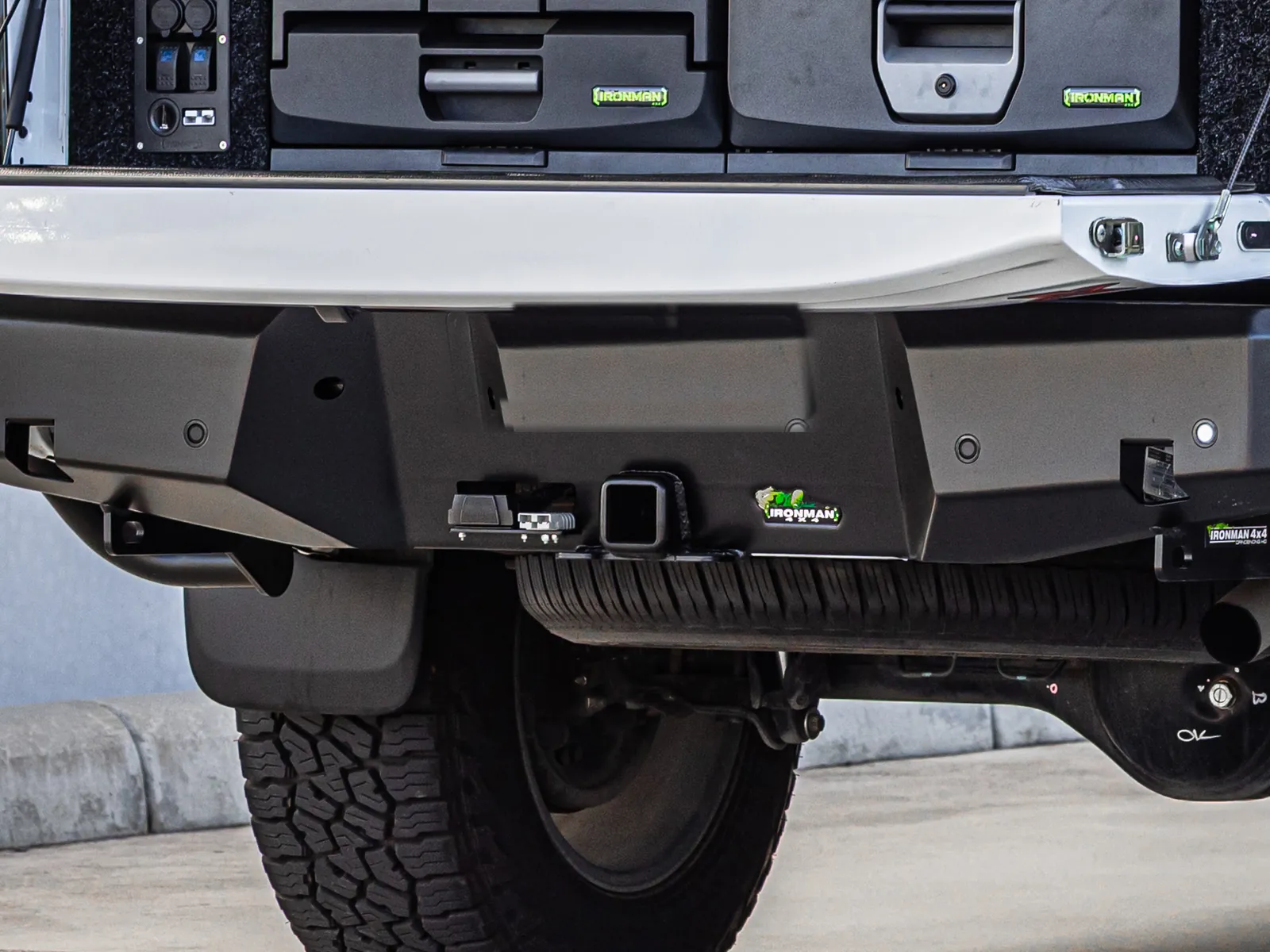 An IRONMAN 4X4 rear bar with a hitch receiver and trailer plug fitted to a white dual cab ute
